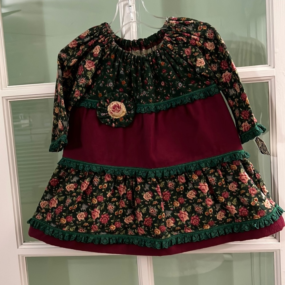 Handmade infant girls’ three tiered flannel dress in a size 18 months.